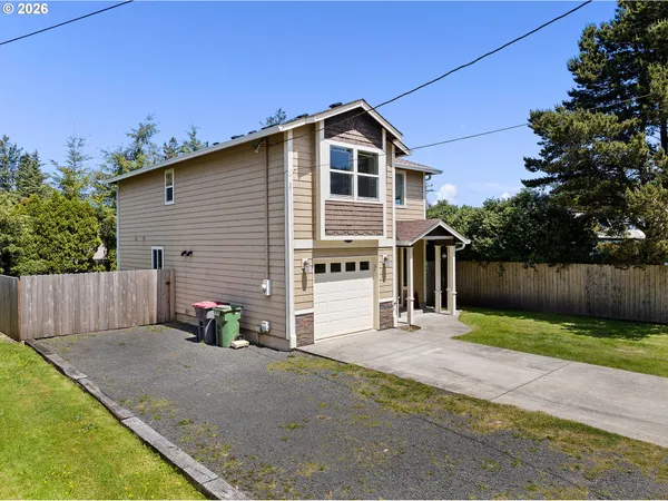 a front view of a house with a yard and garage