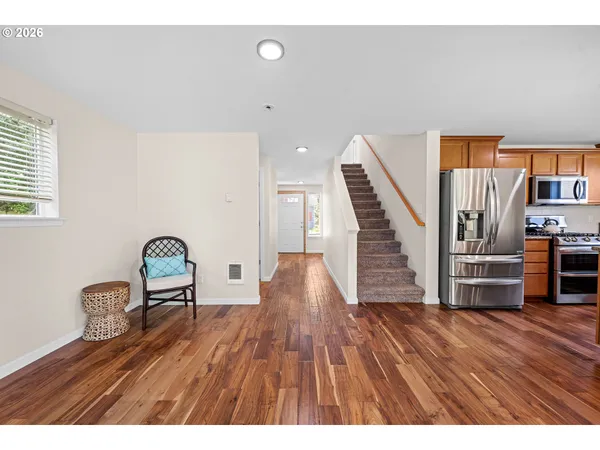 a view of empty room with wooden floor