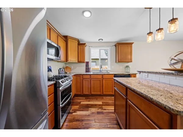 a kitchen with granite countertop a sink stove and cabinets