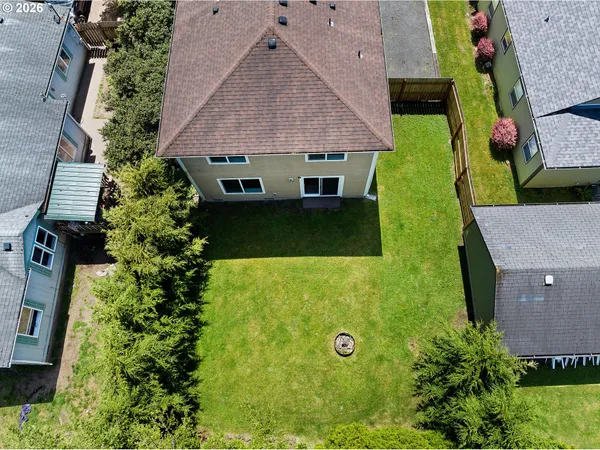 an aerial view of a house with a yard