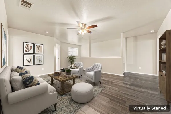 a living room with furniture and a wooden floor