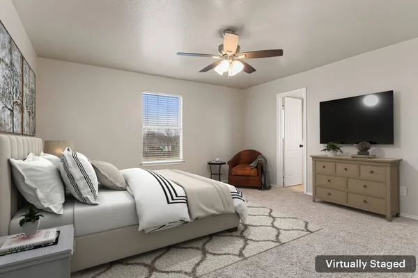 a bedroom with a bed and flat screen tv