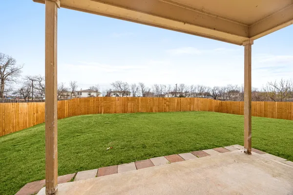 a view of a house with a yard and sitting area