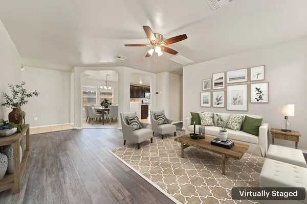 a living room with furniture and wooden floor