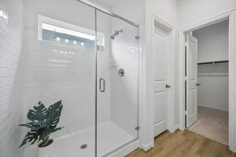 a bathroom with a glass shower door