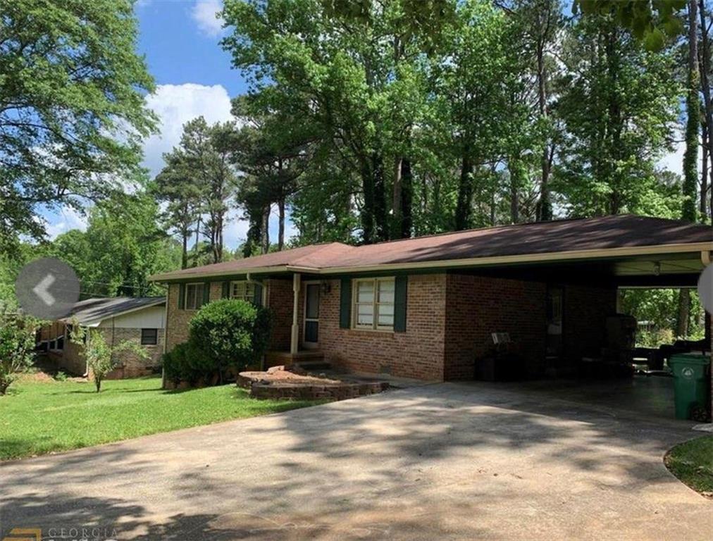 4062 Bouldercrest Road Ellenwood, GA 30294 - Photo 1 of 1 a front view of a house with a garden