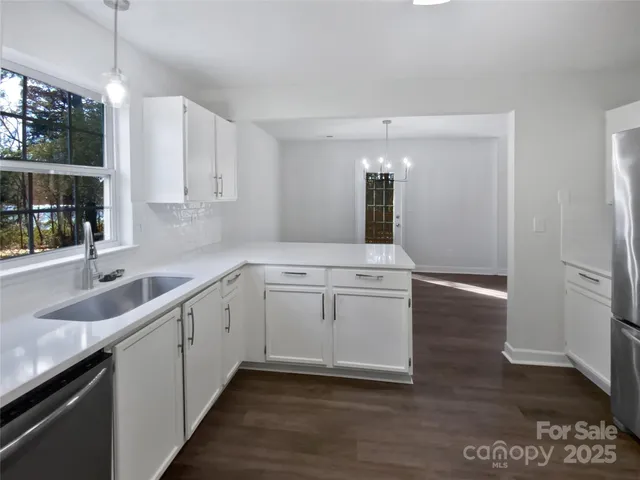 a kitchen with a sink cabinets and window