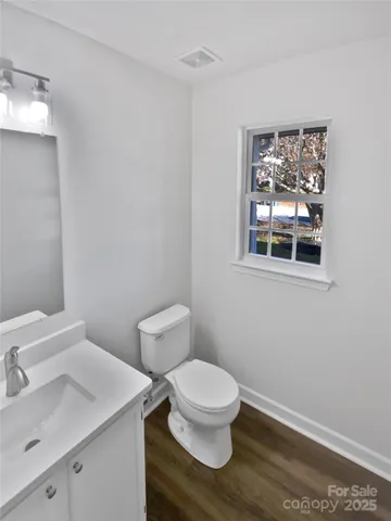 a white toilet sitting next to a bathroom sink
