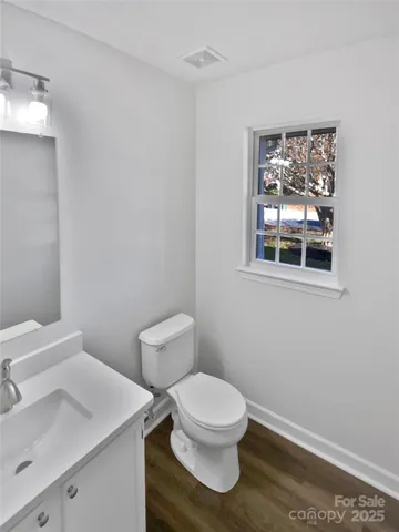 a white toilet sitting next to a bathroom sink