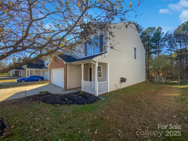 a view of a house with pool and sitting area