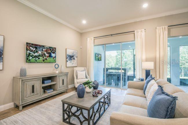 16492 Crane Road Weeki Wachee, FL 34614 - Photo 7 of 24 a living room with furniture a large window and a fireplace