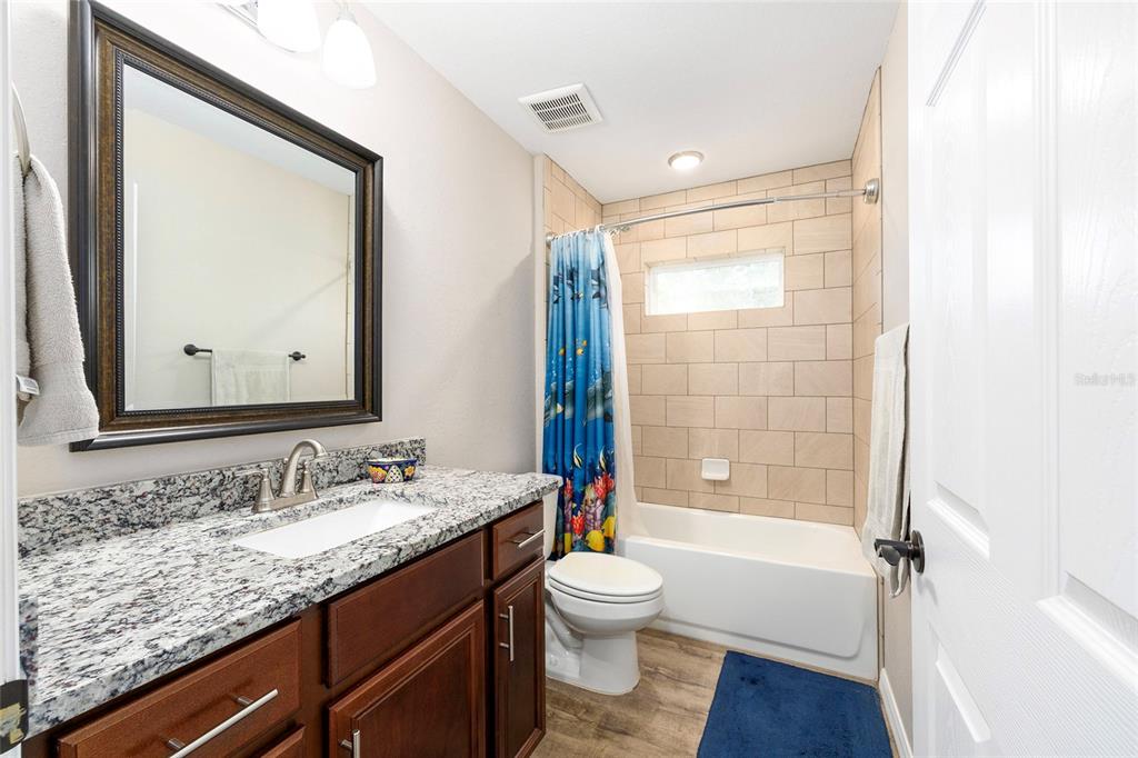 13057 Southwest 85th Circle Ocala, FL 34473 - Photo 17 of 34 a bathroom with a granite countertop sink toilet and shower