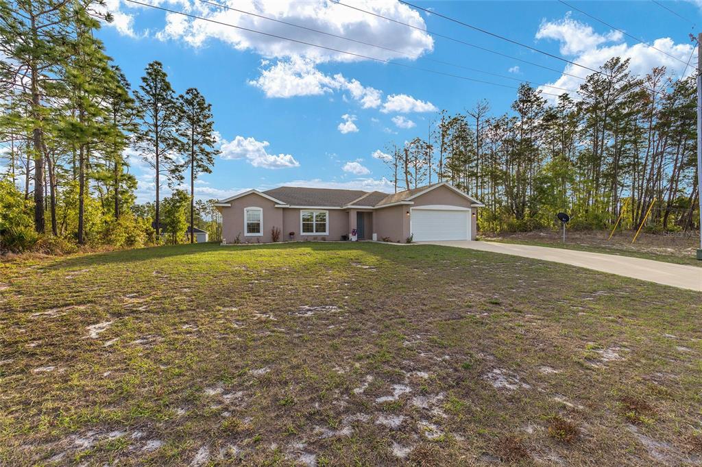 13057 Southwest 85th Circle Ocala, FL 34473 - Photo 22 of 34 a view of a house with a yard