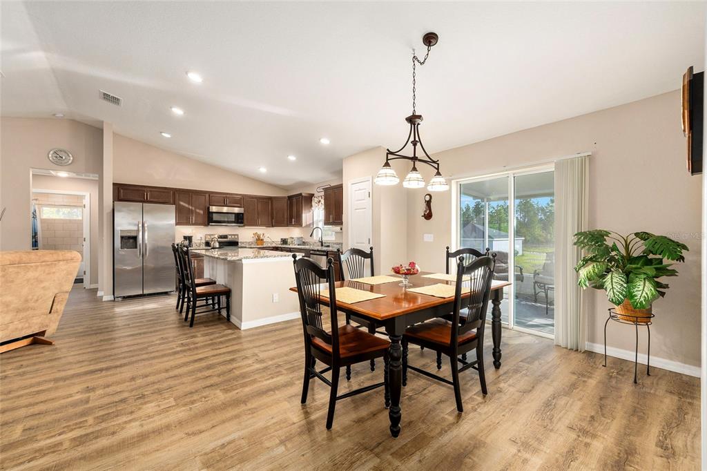 13057 Southwest 85th Circle Ocala, FL 34473 - Photo 4 of 34 a view of a dining room with furniture window and wooden floor