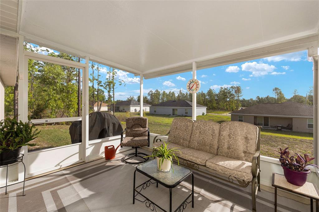 13057 Southwest 85th Circle Ocala, FL 34473 - Photo 5 of 34 a outdoor living space with furniture and garden view