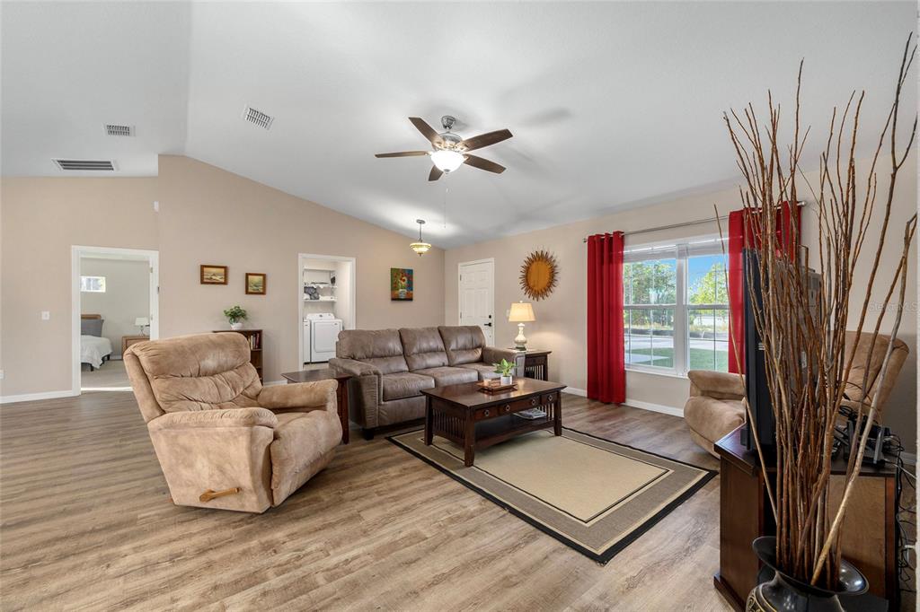 13057 Southwest 85th Circle Ocala, FL 34473 - Photo 6 of 34 a living room with furniture and a large window
