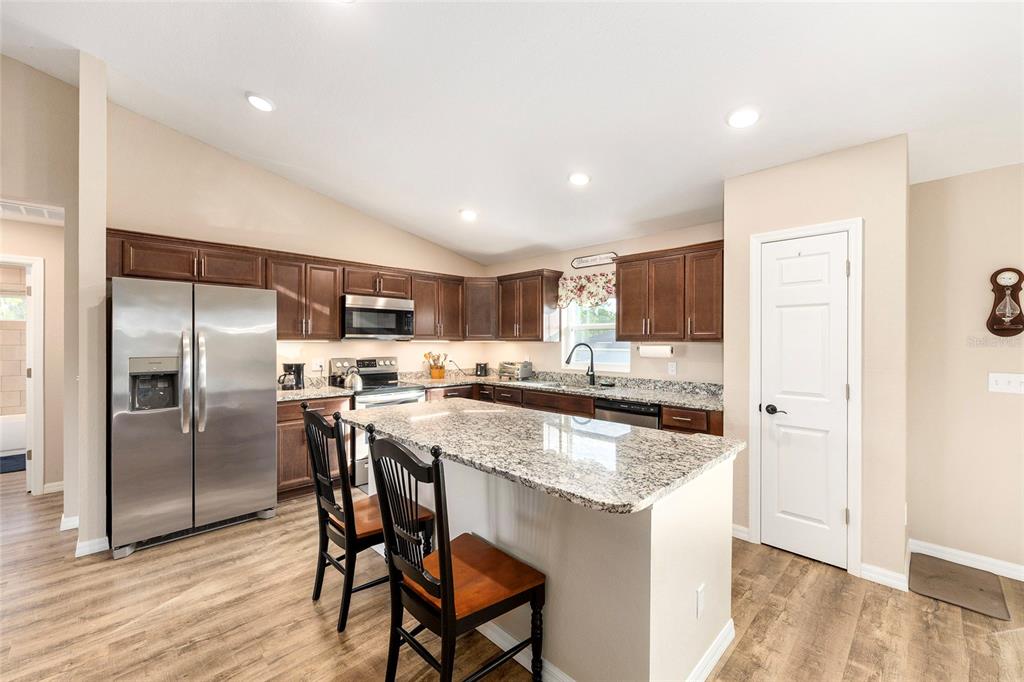 13057 Southwest 85th Circle Ocala, FL 34473 - Photo 7 of 34 a kitchen with a table and chairs