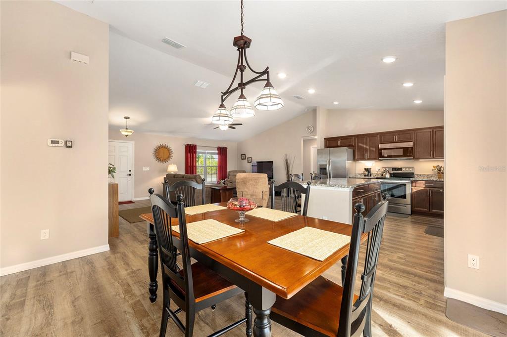 13057 Southwest 85th Circle Ocala, FL 34473 - Photo 10 of 34 a view of a dining area with furniture and wooden floor