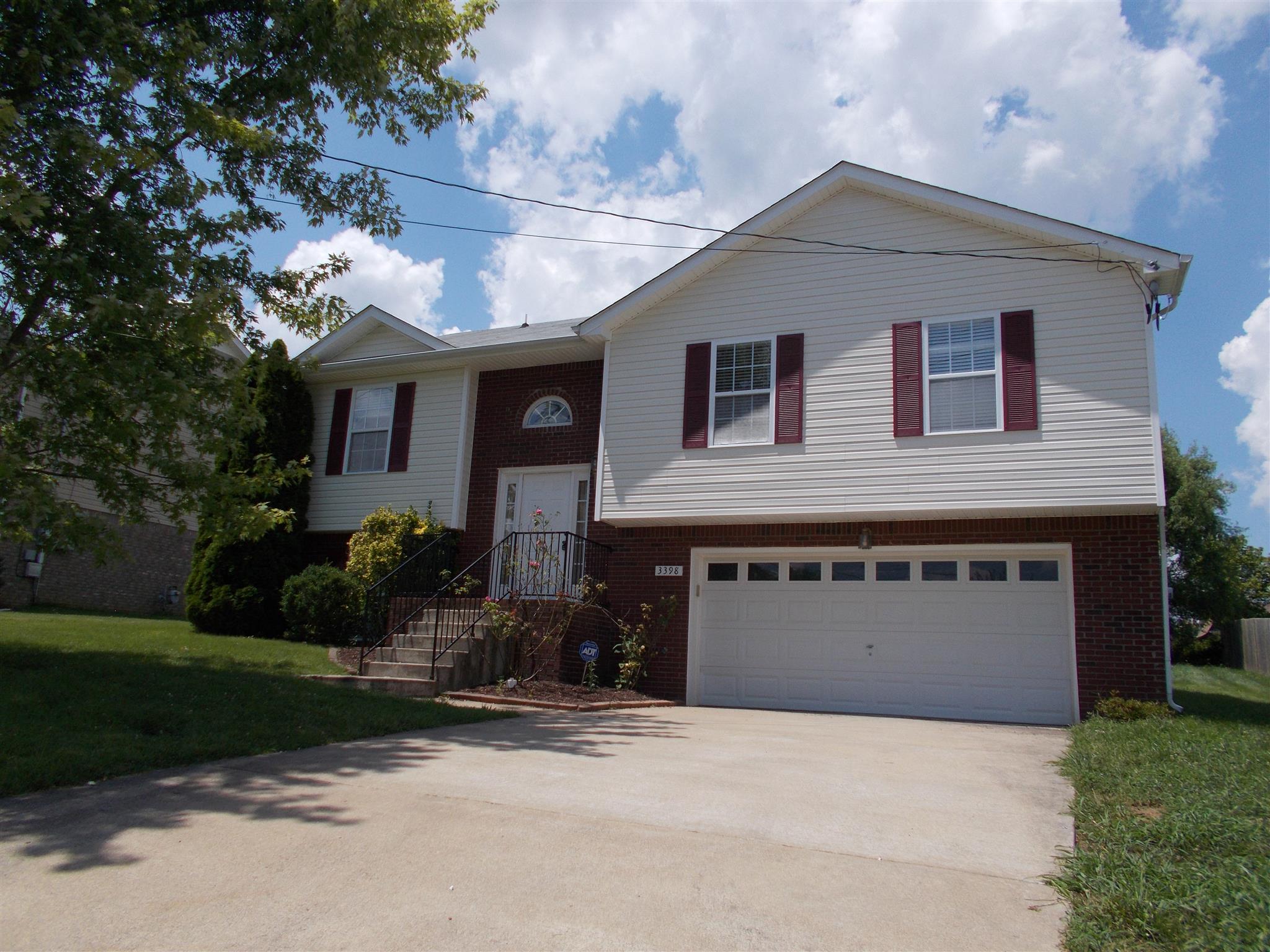 3398 Queensbury Road Clarksville, TN 37042 - Photo 1 of 26 a front view of a house with a yard and garage