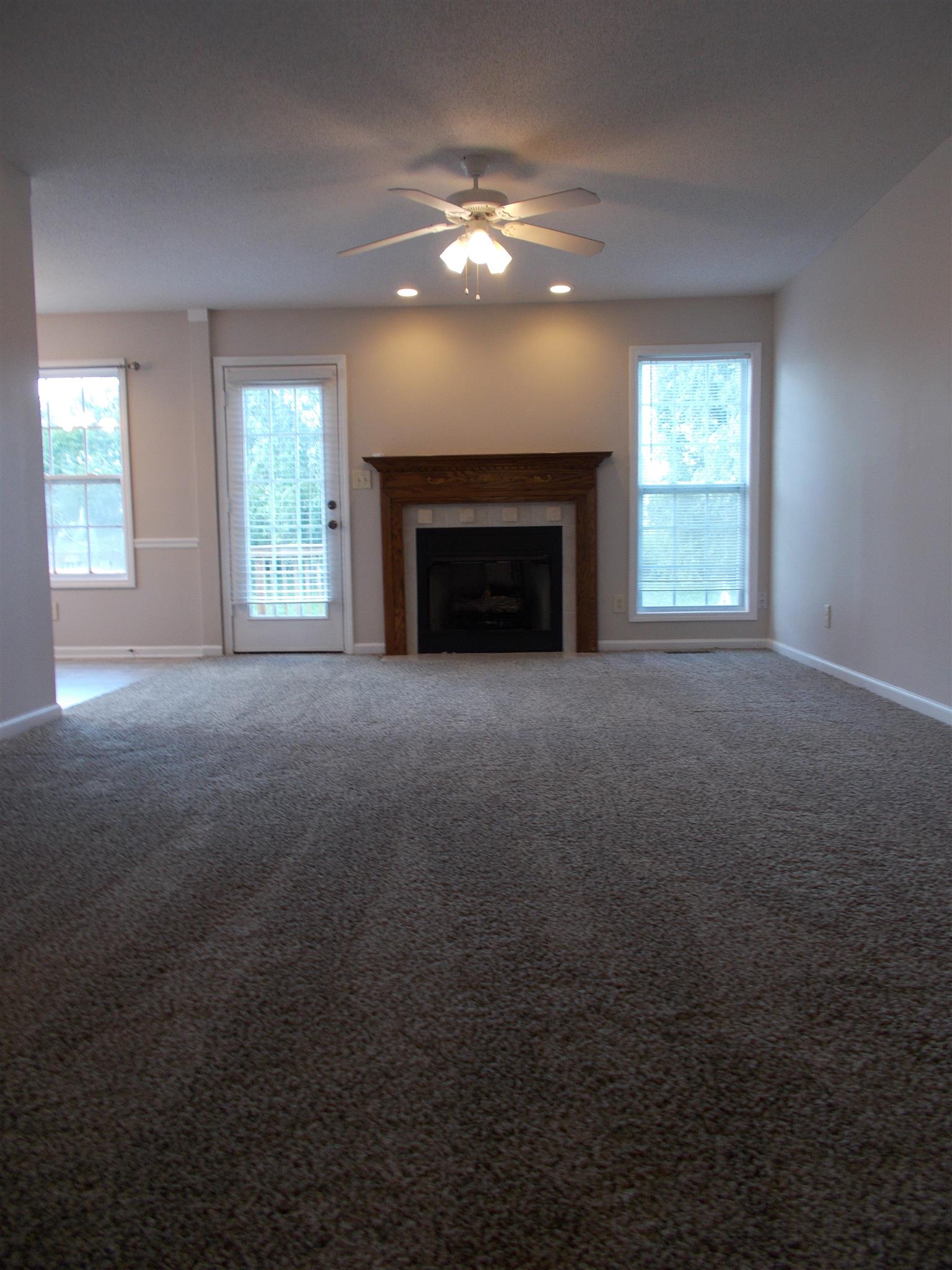 3398 Queensbury Road Clarksville, TN 37042 - Photo 2 of 26 a view of an empty room with a fireplace and a window