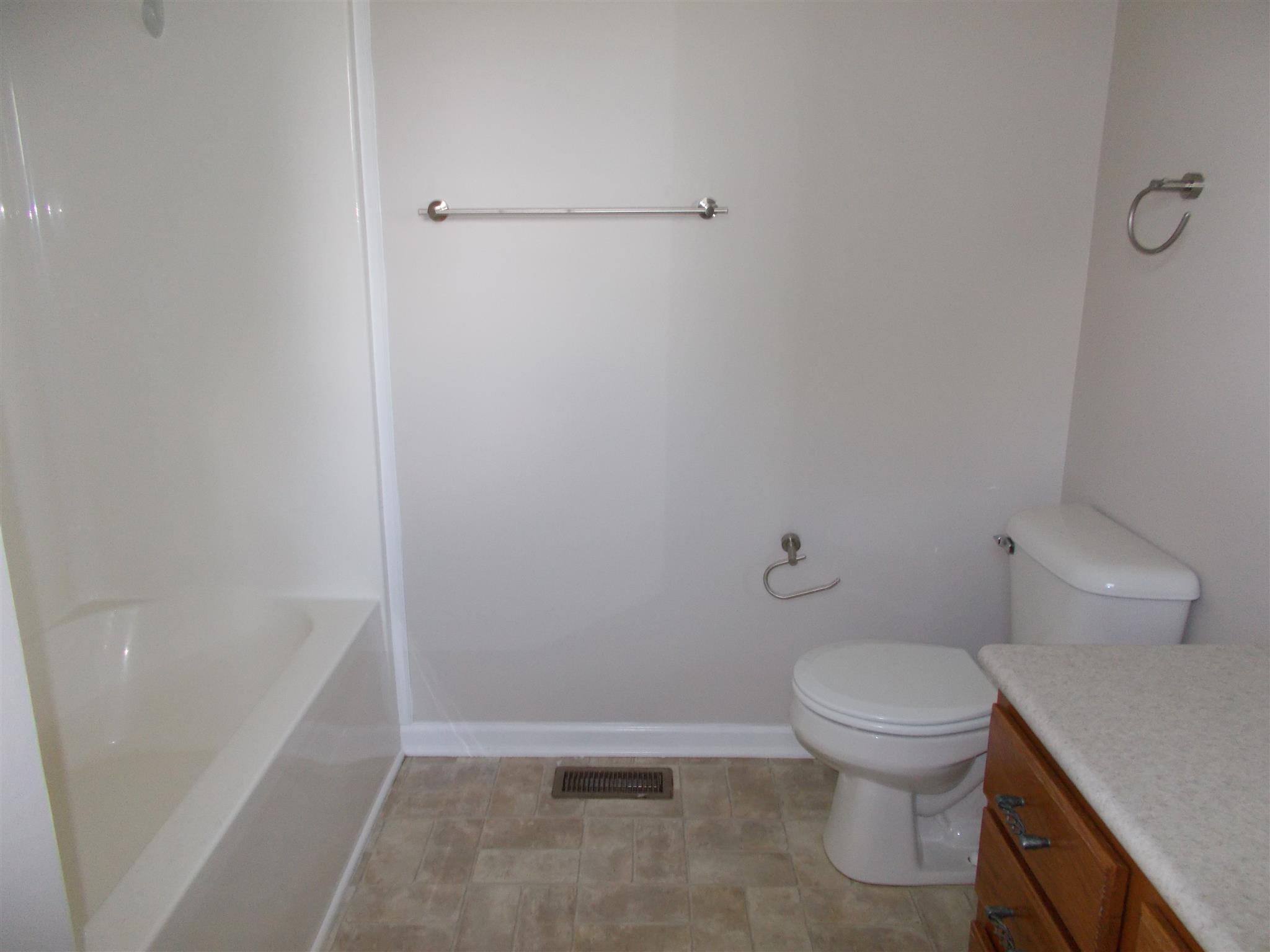 3398 Queensbury Road Clarksville, TN 37042 - Photo 15 of 26 a white toilet sitting next to a bath tub