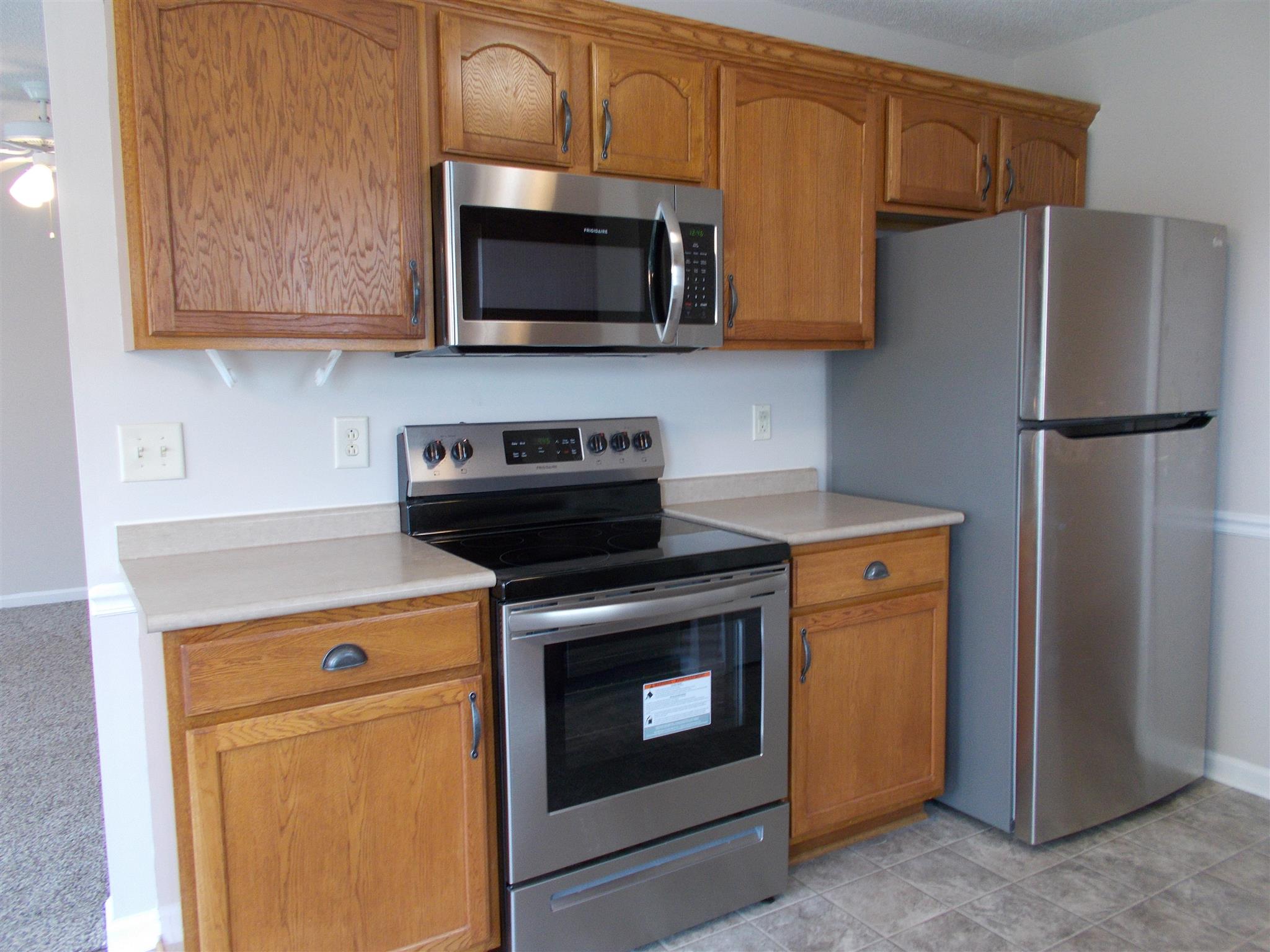 3398 Queensbury Road Clarksville, TN 37042 - Photo 7 of 26 a kitchen with stainless steel appliances a stove a microwave and cabinets