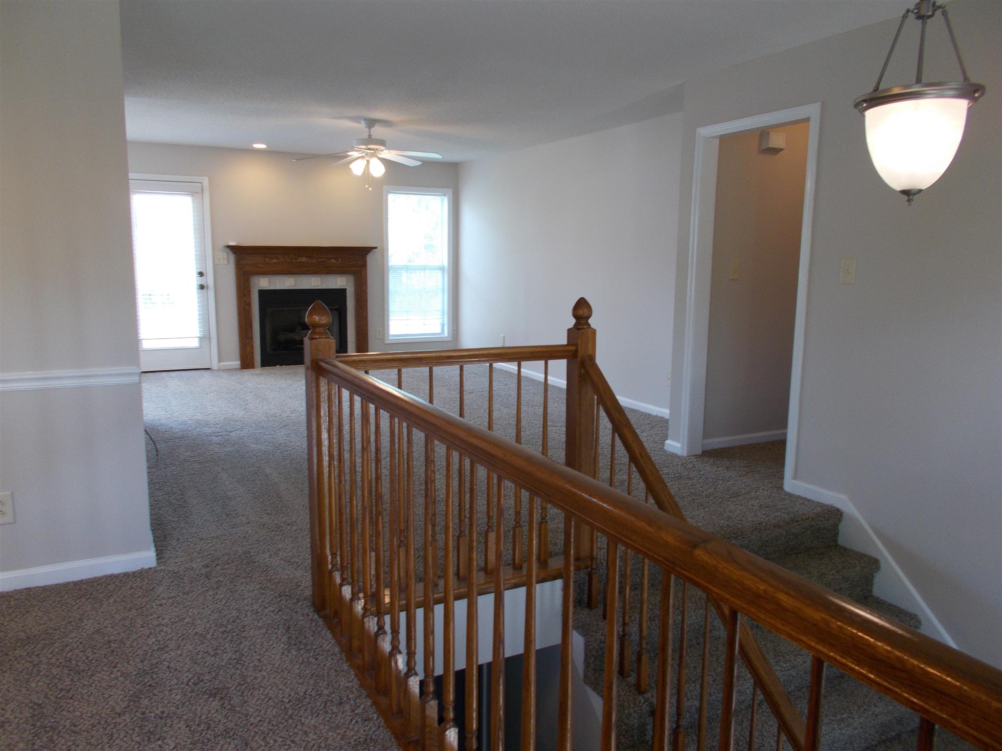 3398 Queensbury Road Clarksville, TN 37042 - Photo 10 of 26 a view of hall with wooden floor and a fireplace
