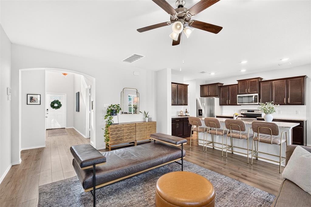 3105 Marston Road Lorena, TX 76655 - Photo 7 of 40 Open-concept living space featuring wood-finish flooring, a ceiling fan with integrated lighting, and white walls