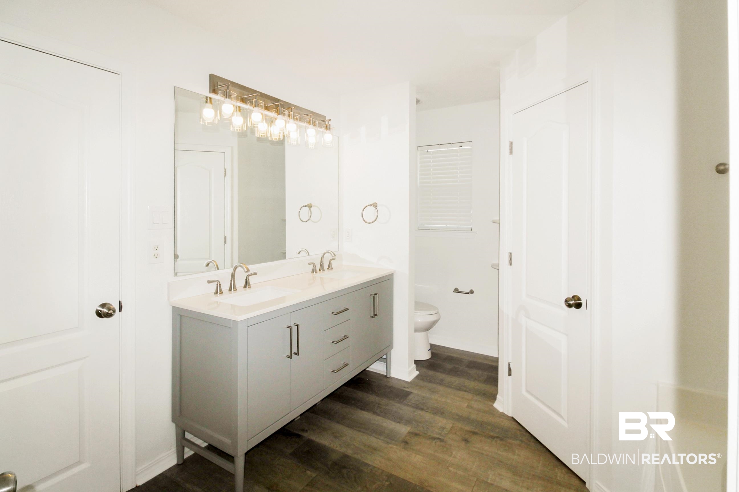 14750 Pawnee Court Foley, AL 36535 - Photo 26 of 34 Full bathroom featuring double vanity and wood finished floors