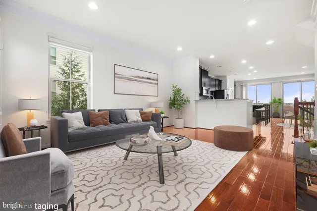 a living room with furniture and kitchen view