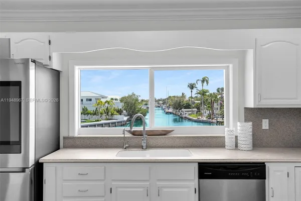 a dining room with furniture and a floor to ceiling window