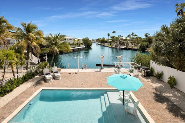 a view of a house with a small yard next to a house