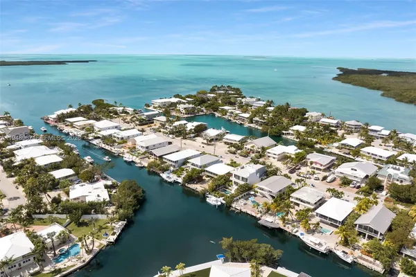 a bathroom with a granite countertop double vanity sink and a mirror