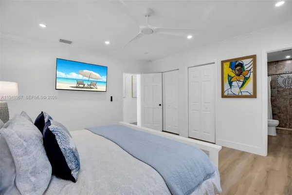 a bedroom with a bed and a lamp