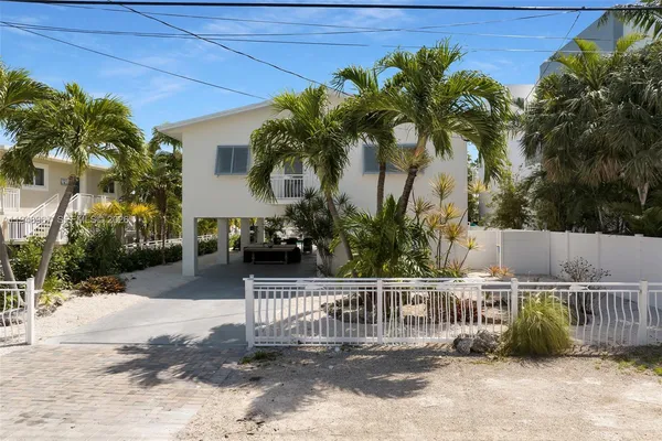 an aerial view of a house with yard and sitting area