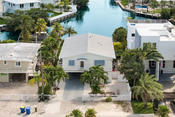 a living room with furniture and painting on the wall