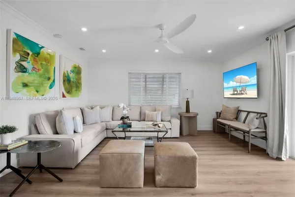 a living room with furniture and a dining table with kitchen view