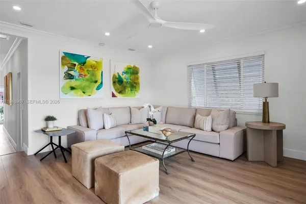 a kitchen with stainless steel appliances granite countertop a refrigerator a stove and white cabinets with wooden floor