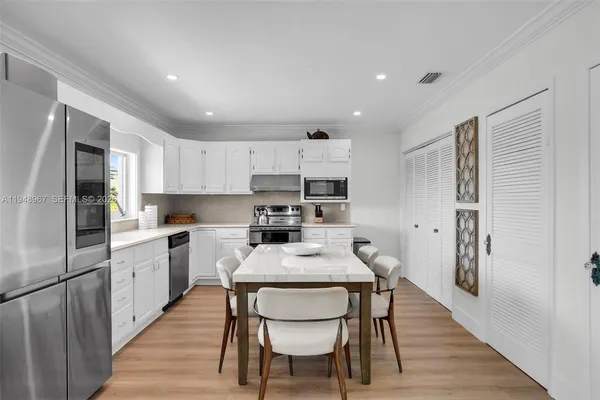 an aerial view of a house with a yard and lake view