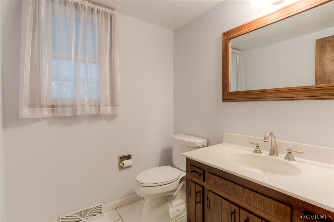 12901 Middlebrook Road Chester, VA 23831 - Photo 12 of 38 a bathroom with a sink a toilet and mirror