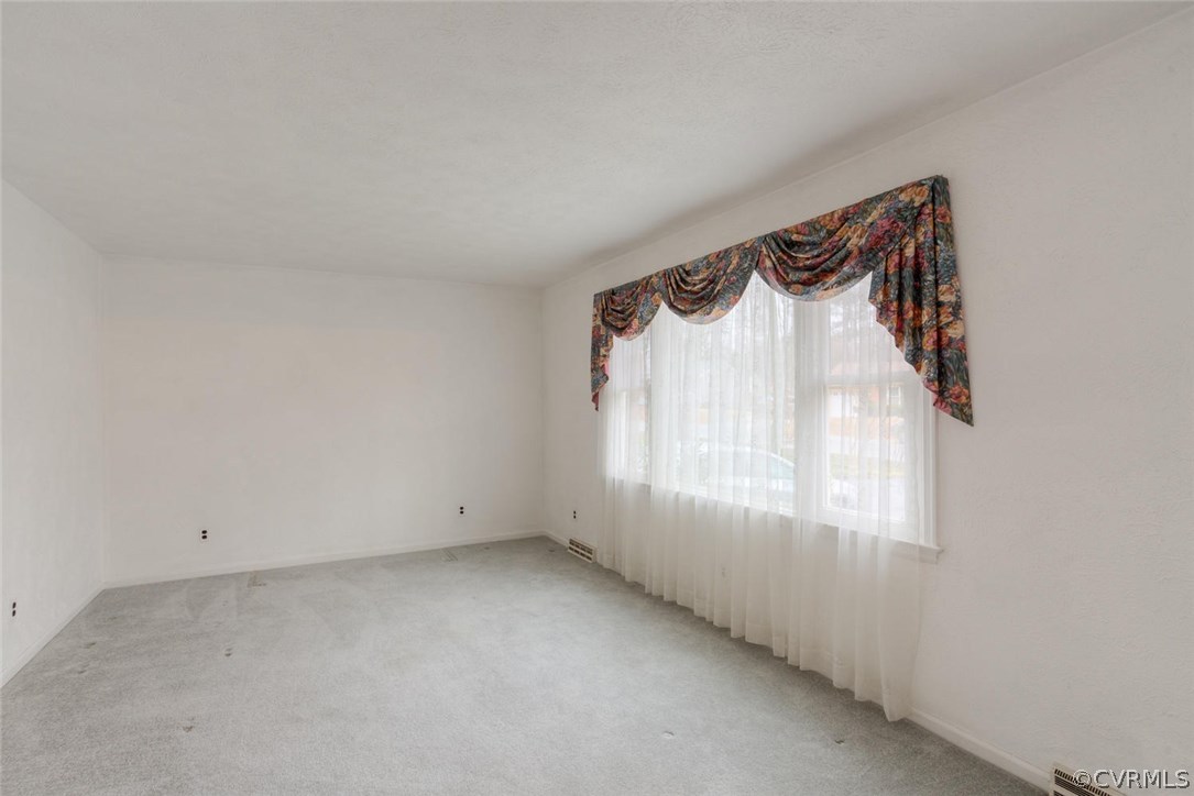 12901 Middlebrook Road Chester, VA 23831 - Photo 7 of 38 a view of a room that has a window and a shower curtain