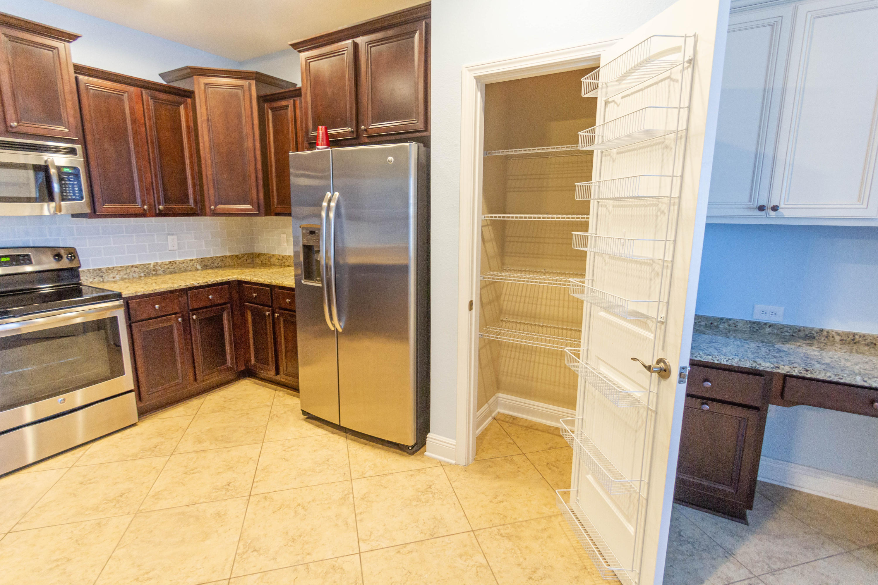530 Pin Oak Loop Santa Rosa Beach, FL 32459 - Photo 8 of 53 a kitchen with stainless steel appliances granite countertop a refrigerator and a sink