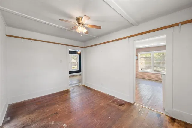 wooden floor in an empty room with a window