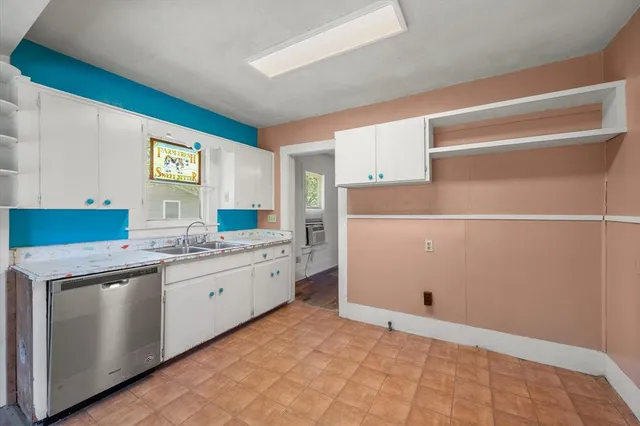 a kitchen with a cabinets and white appliances