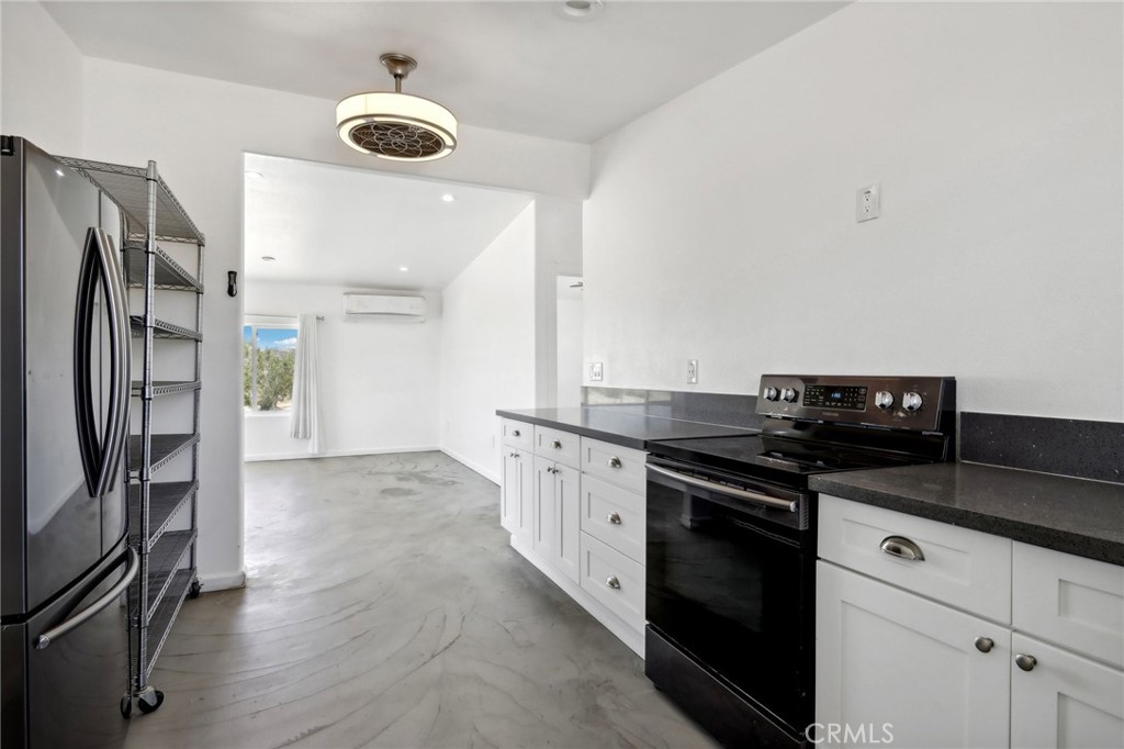 51474 Mills Road Johnson Valley, CA 92285 - Photo 13 of 56 a kitchen with stainless steel appliances granite countertop a stove and a refrigerator