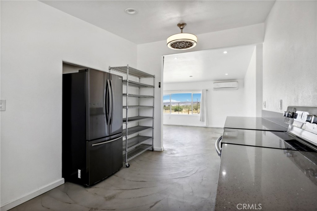 51474 Mills Road Johnson Valley, CA 92285 - Photo 14 of 56 a view of a refrigerator in kitchen and an empty room