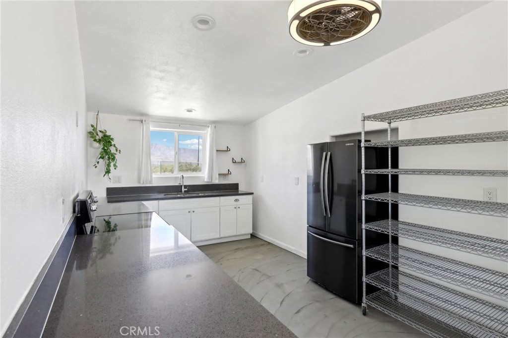51474 Mills Road Johnson Valley, CA 92285 - Photo 16 of 56 a large kitchen with a large window and stainless steel appliances