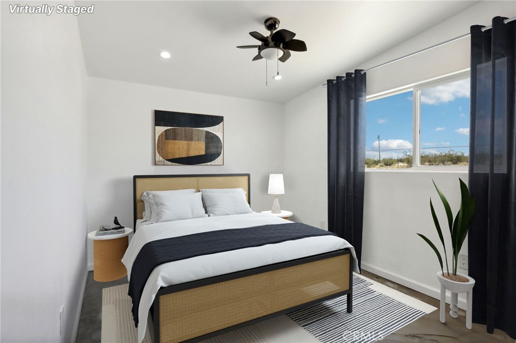 51474 Mills Road Johnson Valley, CA 92285 - Photo 17 of 56 a bedroom with a bed and a chandelier