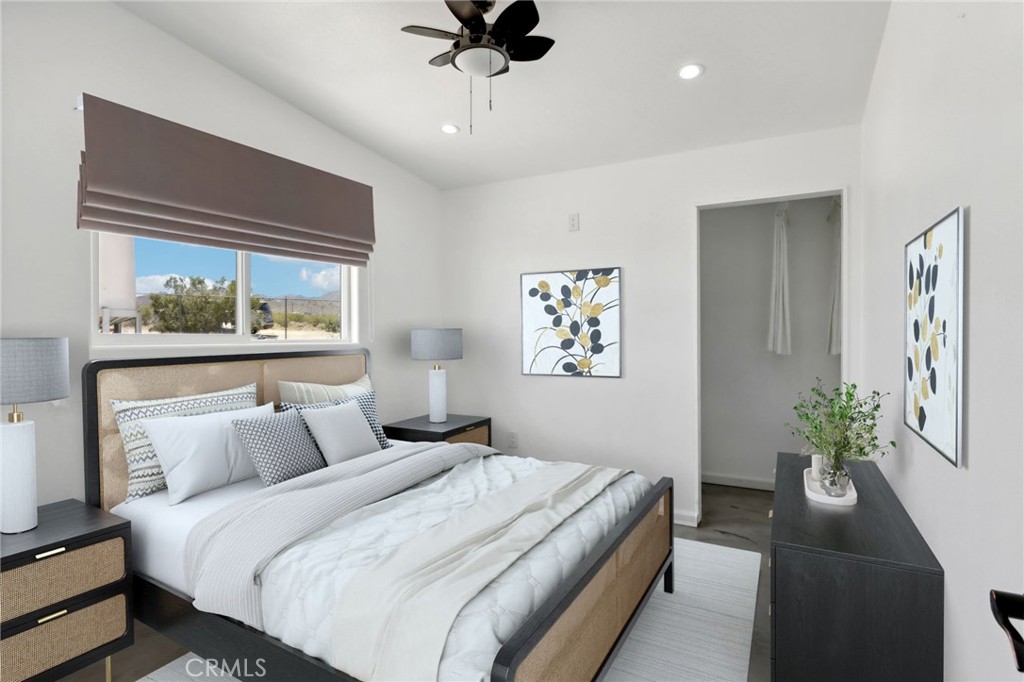 51474 Mills Road Johnson Valley, CA 92285 - Photo 19 of 56 a bedroom with a large bed and a potted plant