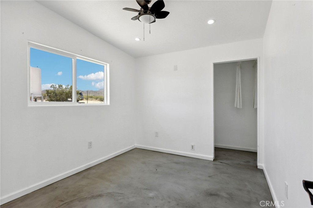 51474 Mills Road Johnson Valley, CA 92285 - Photo 20 of 56 an empty room with a ceiling fan and window